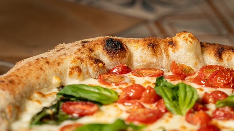 Classic cheese pizza at a restaurant table