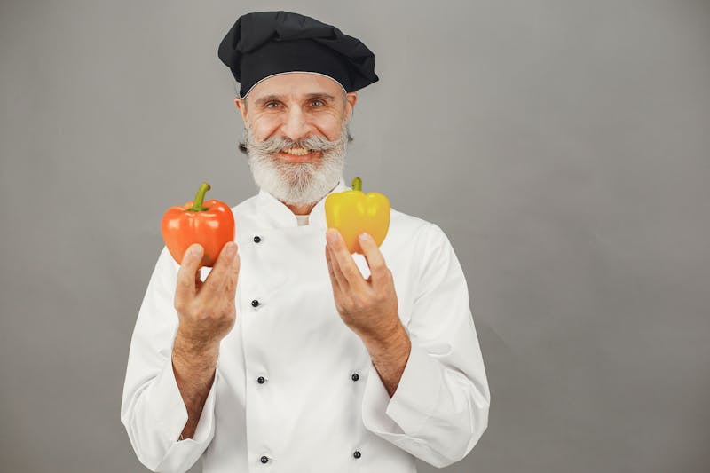 Chef carefully crafting a pizza in the kitchen